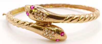 An 18ct gold, ruby and diamond snake bangle